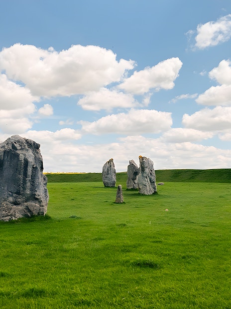 Avebury stone circle under a blue sky on a guided day tour from London.