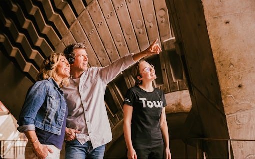 Visitors on a guided walking tour inside Sydney Opera House, wearing headsets.