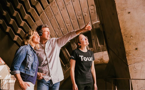 Visitors on a guided walking tour inside Sydney Opera House, wearing headsets.