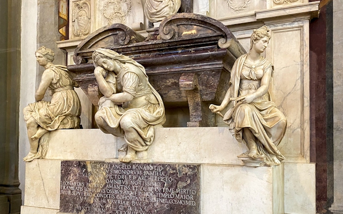 Santa Croce sculptures in Florence, featuring detailed marble figures on a tomb.