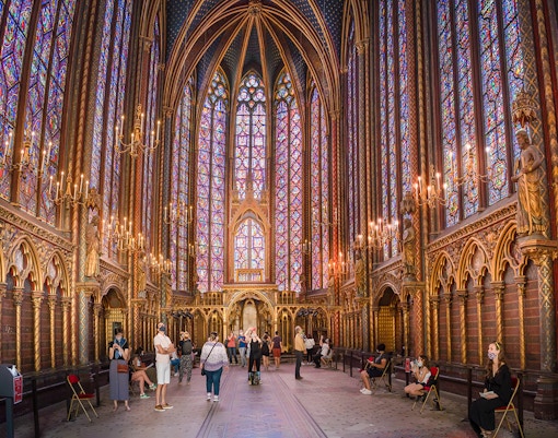 Stained glass windows inside Sainte Chapelle, Paris, showcasing biblical scenes.