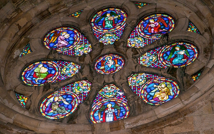 Stained glass window depicting religious figures in a church.