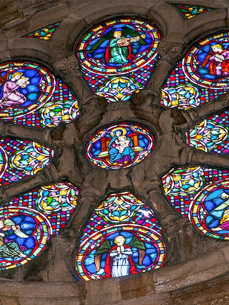 Stained glass window depicting religious figures in a church.