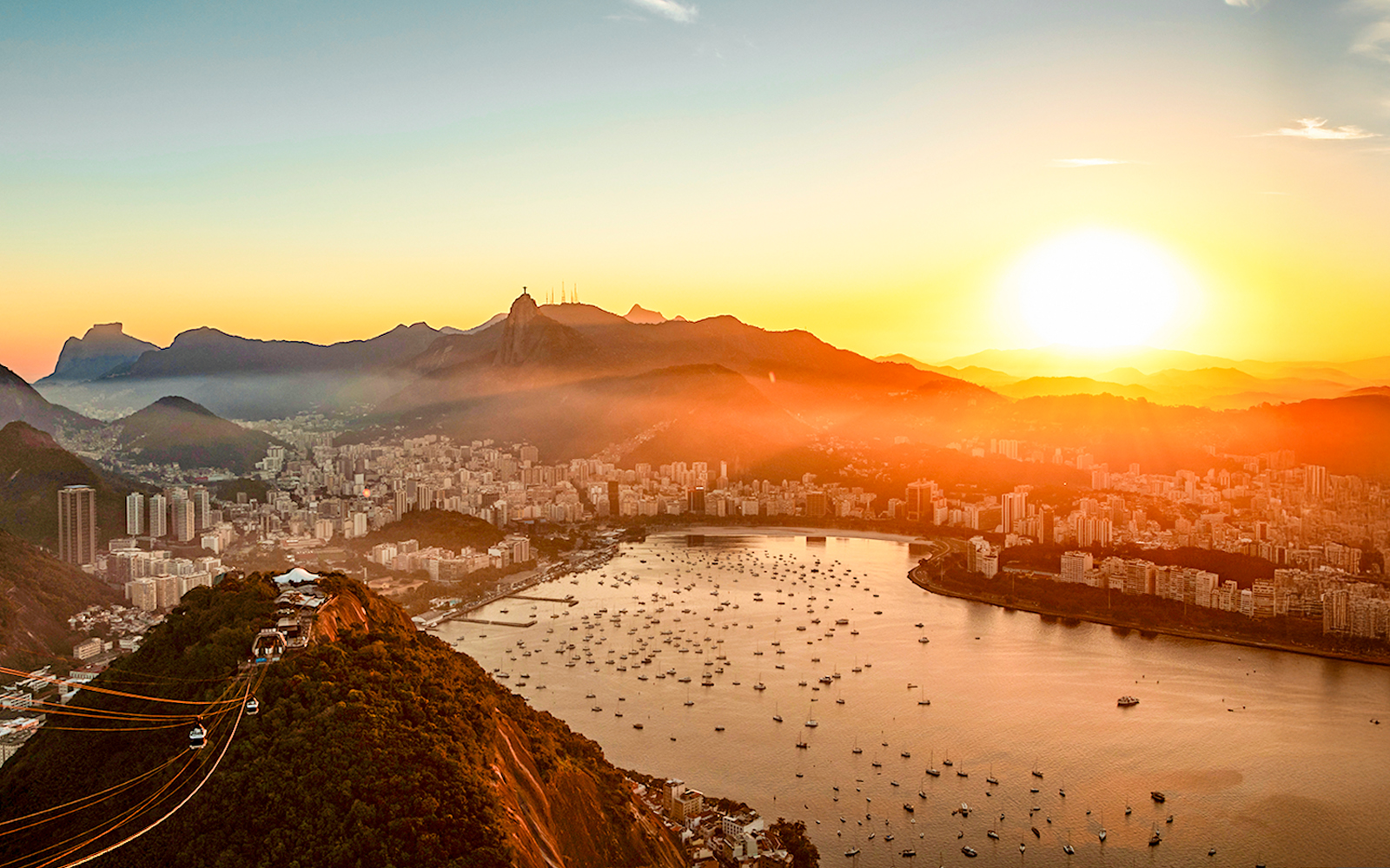 Aerial view of Guanabara Bay, Christ the Redeemer, and Sugarloaf Mountain at sunset, Rio de Janeiro.