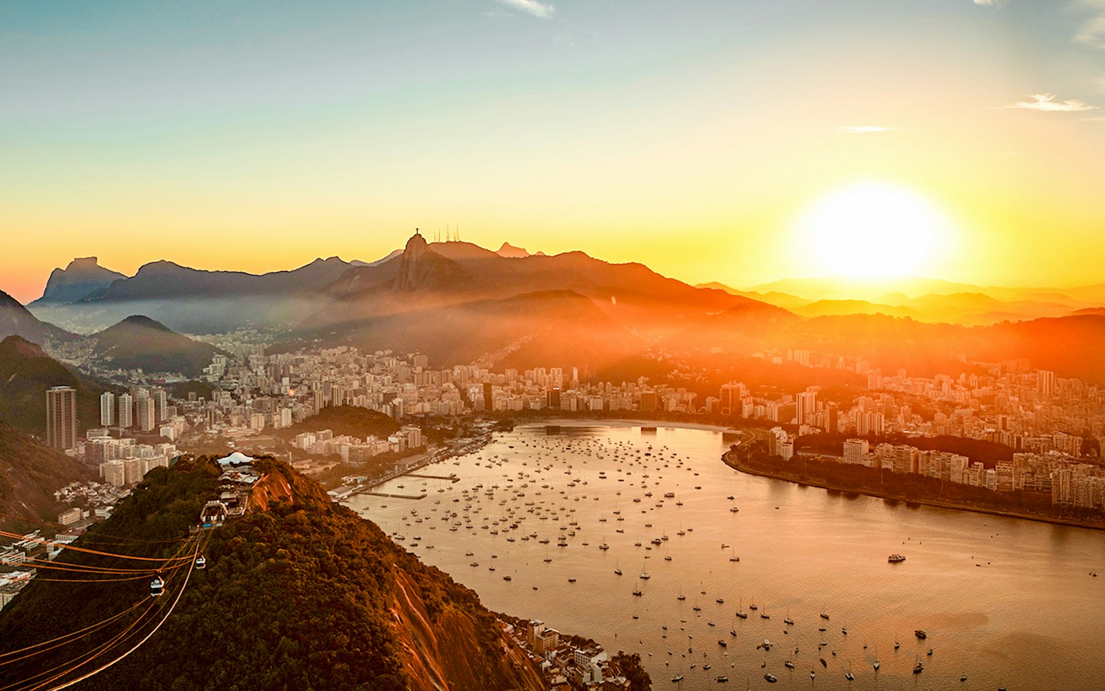 Aerial view of Guanabara Bay, Christ the Redeemer, and Sugarloaf Mountain at sunset, Rio de Janeiro.