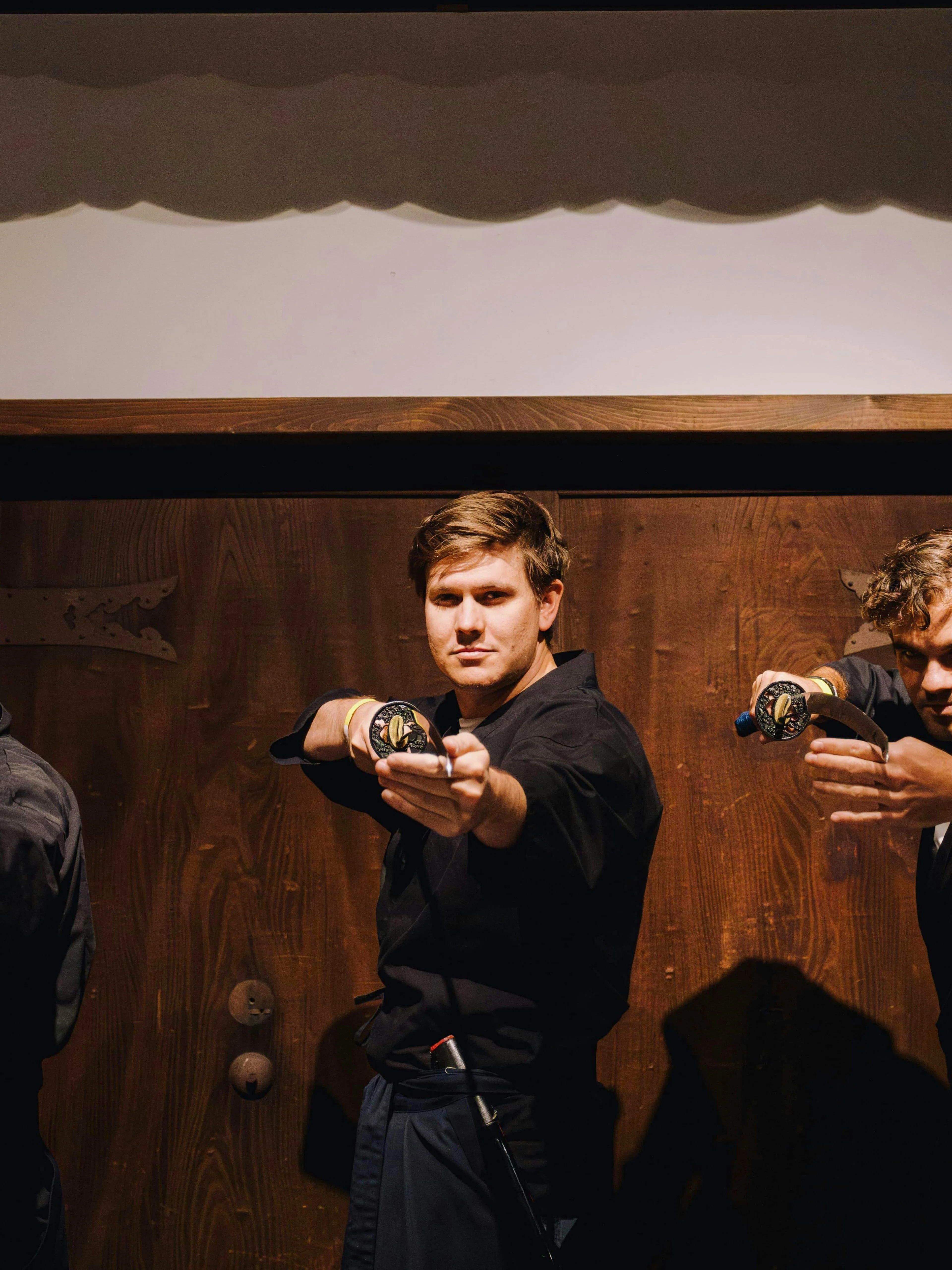 Tourists practicing sword techniques at Samurai Museum Tokyo in Shinjuku.