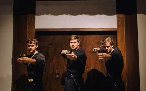 Tourists practicing sword techniques at Samurai Museum Tokyo in Shinjuku.