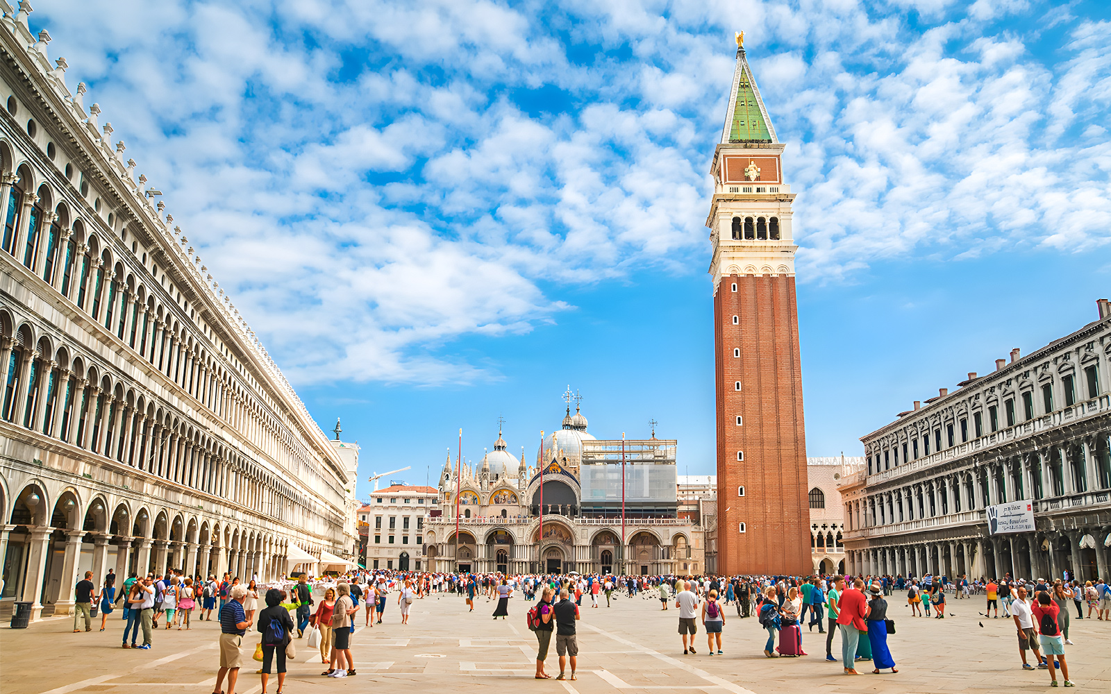 St. Mark's Square with Campanile and Basilica in Venice, Italy, crowded with tourists.