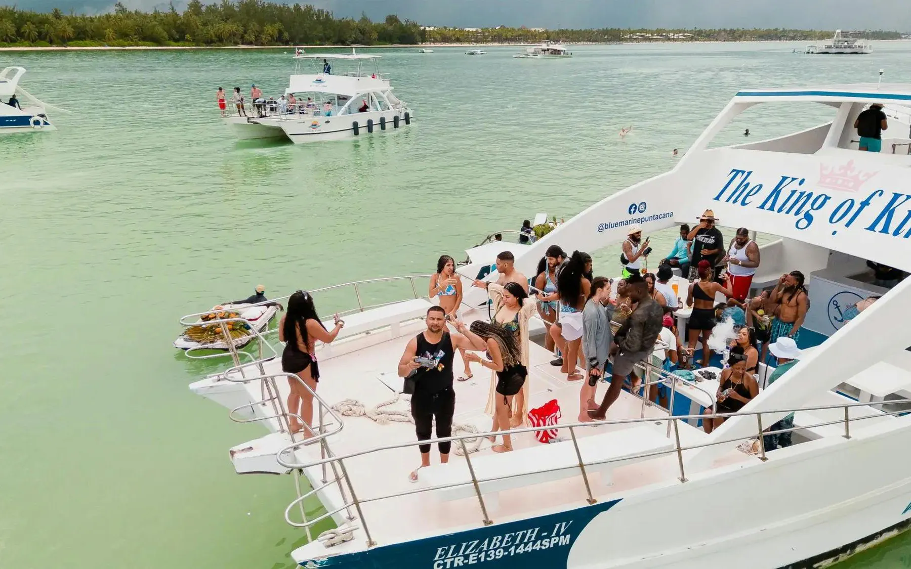 Boat party with people enjoying drinks and music on the Caribbean Sea near Punta Cana.