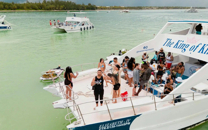 Boat party with people enjoying drinks and music on the Caribbean Sea near Punta Cana.