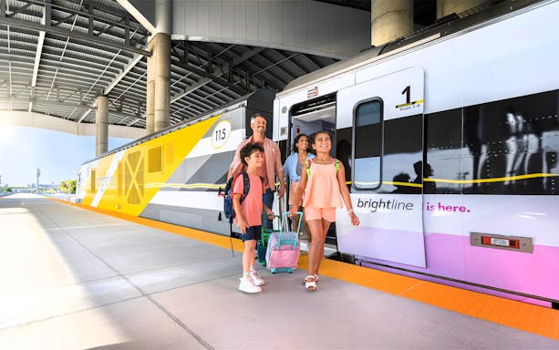 Family boarding Brightline train for Miami trip with open top bus and islands boat cruise.