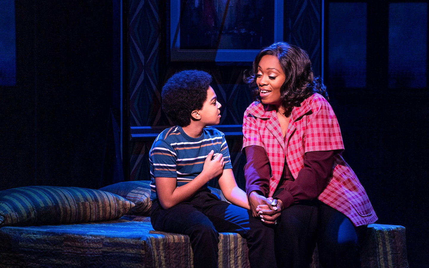 Child and adult sharing a moment on stage in MJ Das Musical.