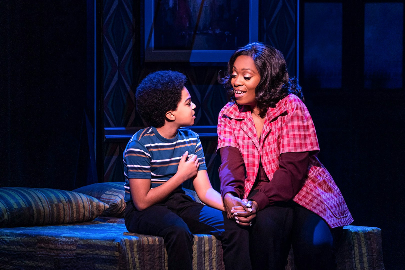 Child and adult sharing a moment on stage in MJ Das Musical.