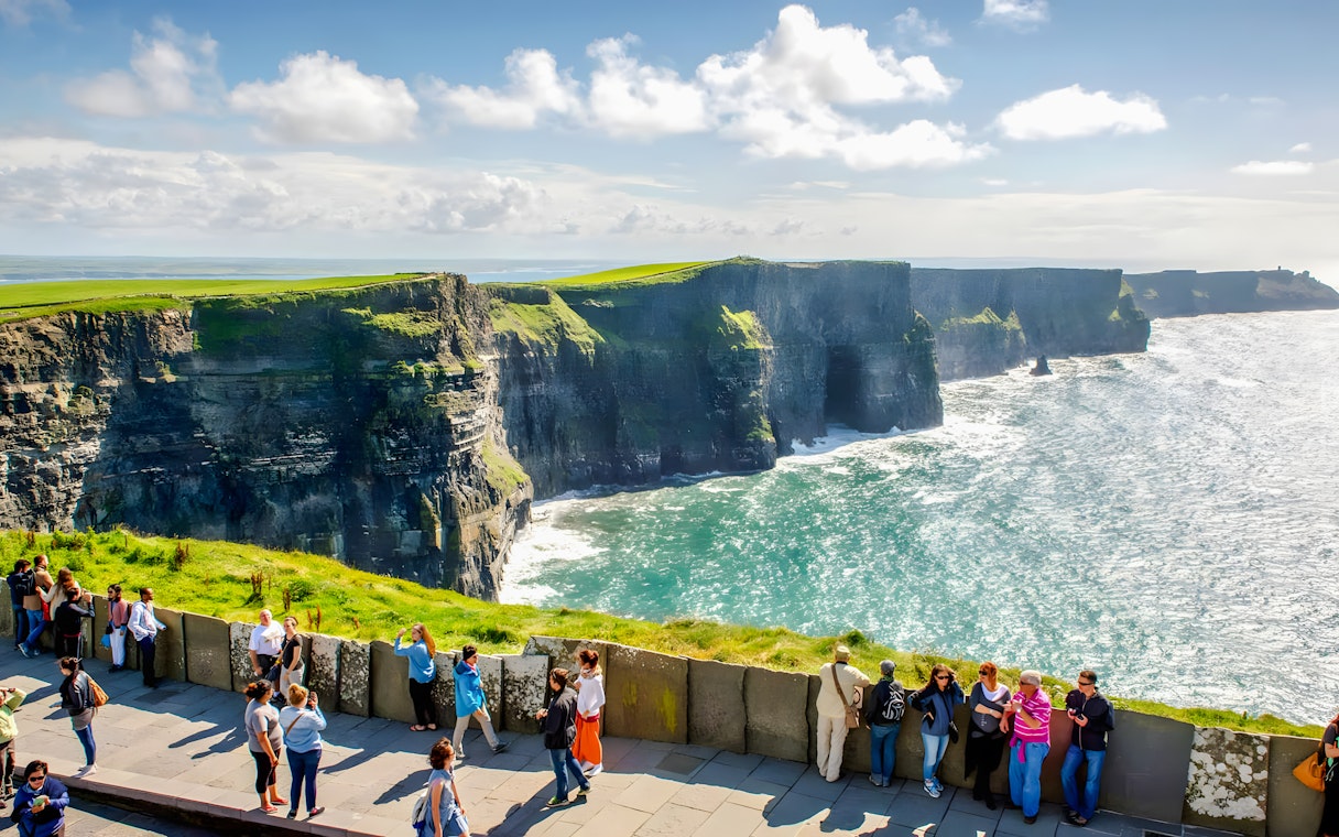 Tourists viewing the Cliffs of Moher in County Clare, Ireland.