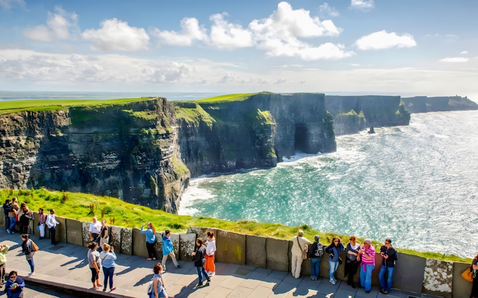 Tourists viewing the Cliffs of Moher in County Clare, Ireland.