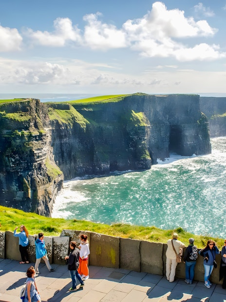 Tourists viewing the Cliffs of Moher in County Clare, Ireland.