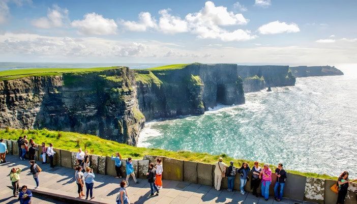 Tourists viewing the Cliffs of Moher in County Clare, Ireland.