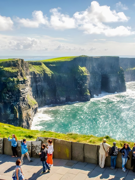 Tourists viewing the Cliffs of Moher in County Clare, Ireland.