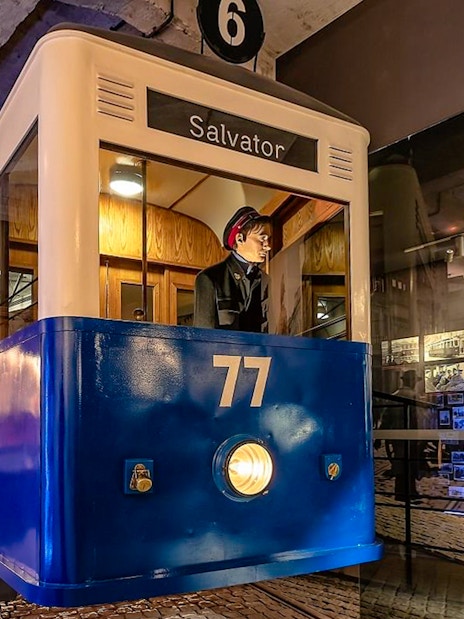 Tram exhibit at Oskar Schindler's Factory museum, Krakow, with historical photos.
