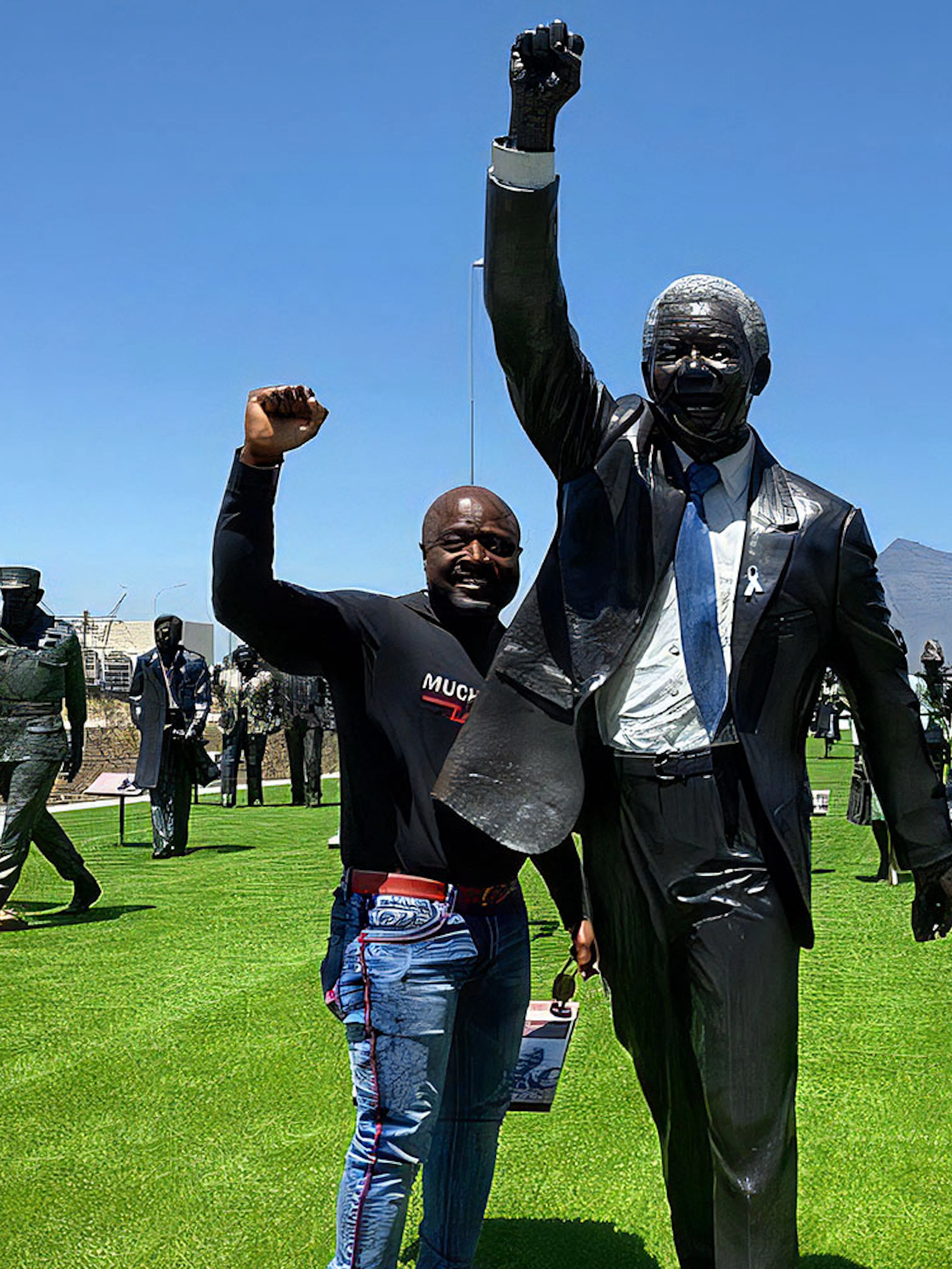 Tourist with Nelson Mandela statue at Robben Island, South Africa.