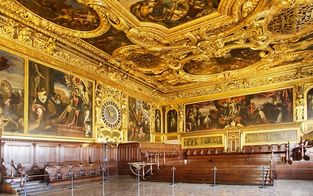 Doge's Palace interior with ornate gold ceiling and historic paintings, Venice walking tour.