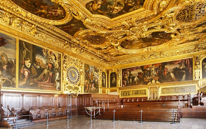 Doge's Palace interior with ornate gold ceiling and historic paintings, Venice walking tour.