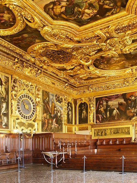 Doge's Palace interior with ornate gold ceiling and historic paintings, Venice walking tour.