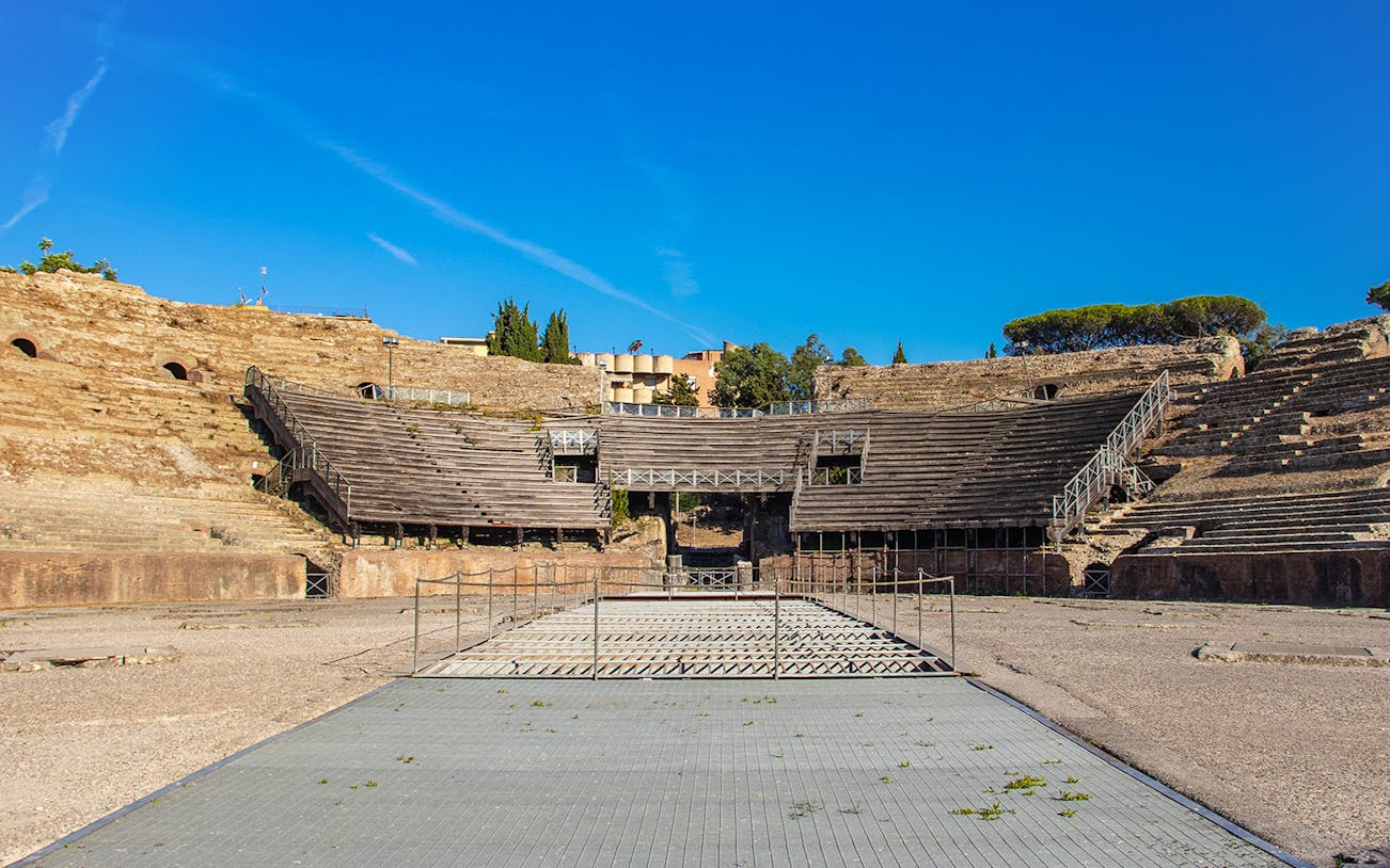 Flavian Amphitheater in Pozzuoli with ancient stone seating and central arena.