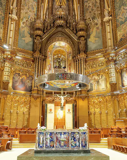 Monserrat Monastery altar with ornate gold detailing and religious artwork.