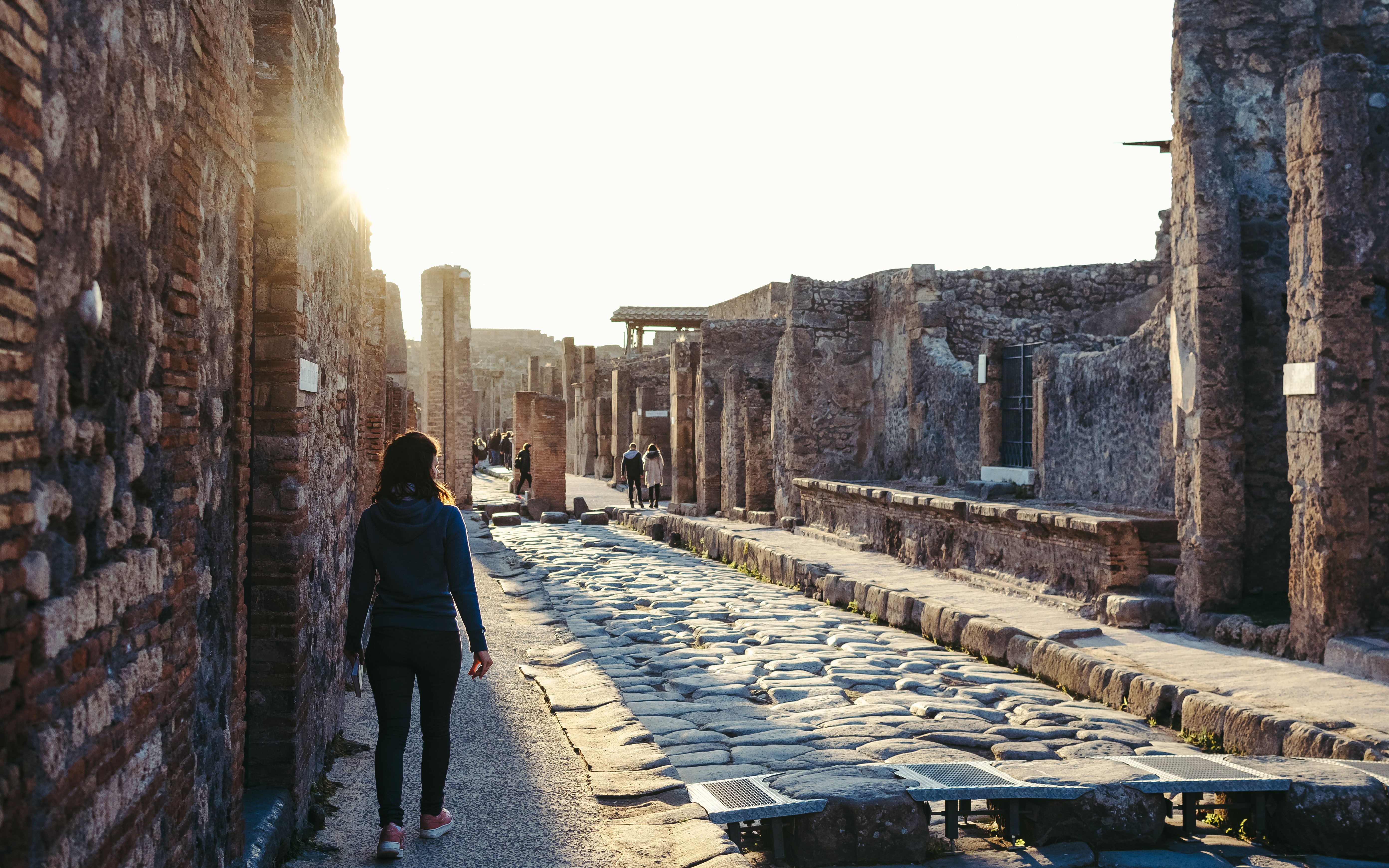 Guest walking through ancient streets of Pompeii, Italy.
