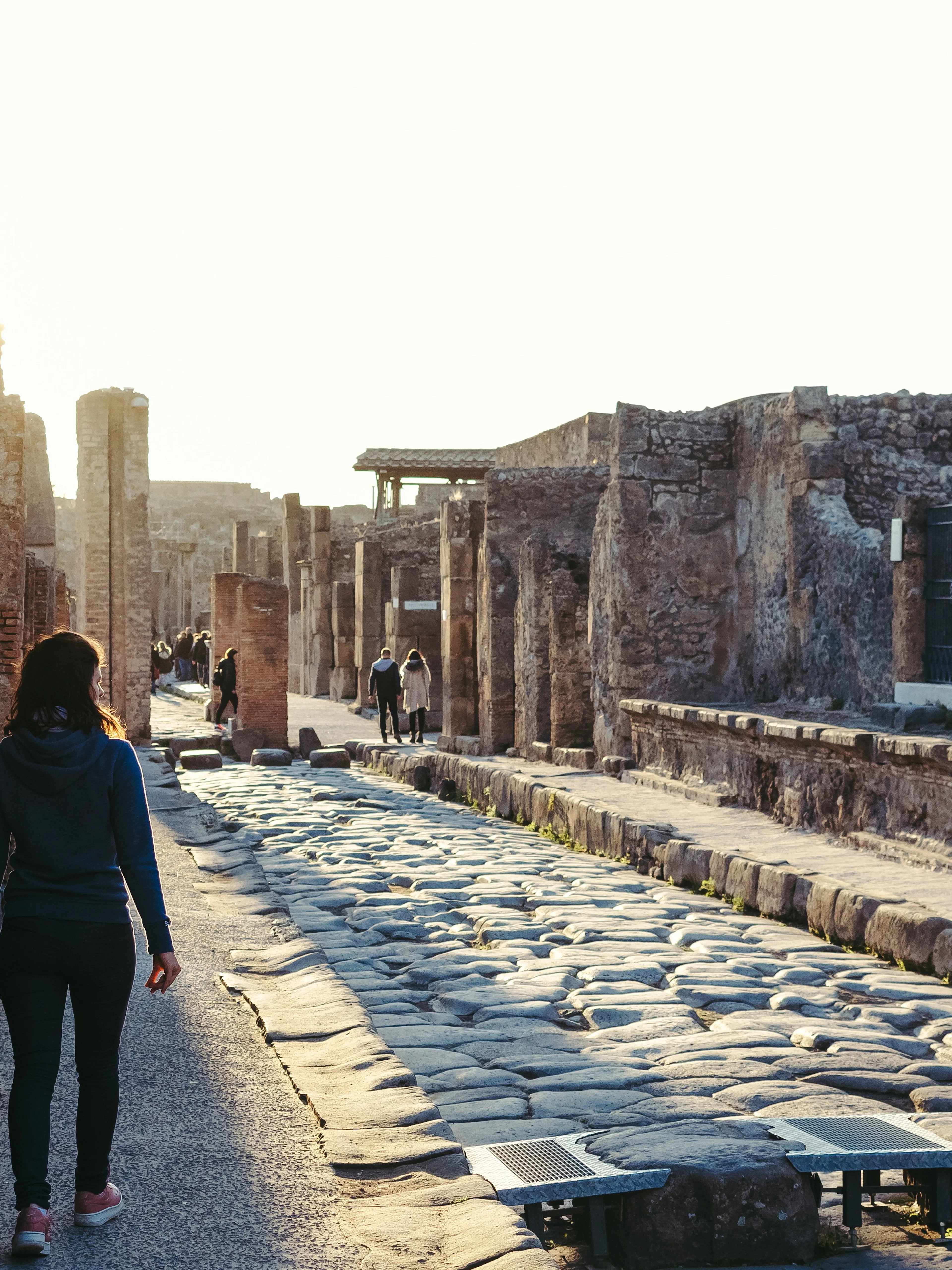 Guest walking through ancient streets of Pompeii, Italy.