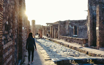 Guest walking through ancient streets of Pompeii, Italy.