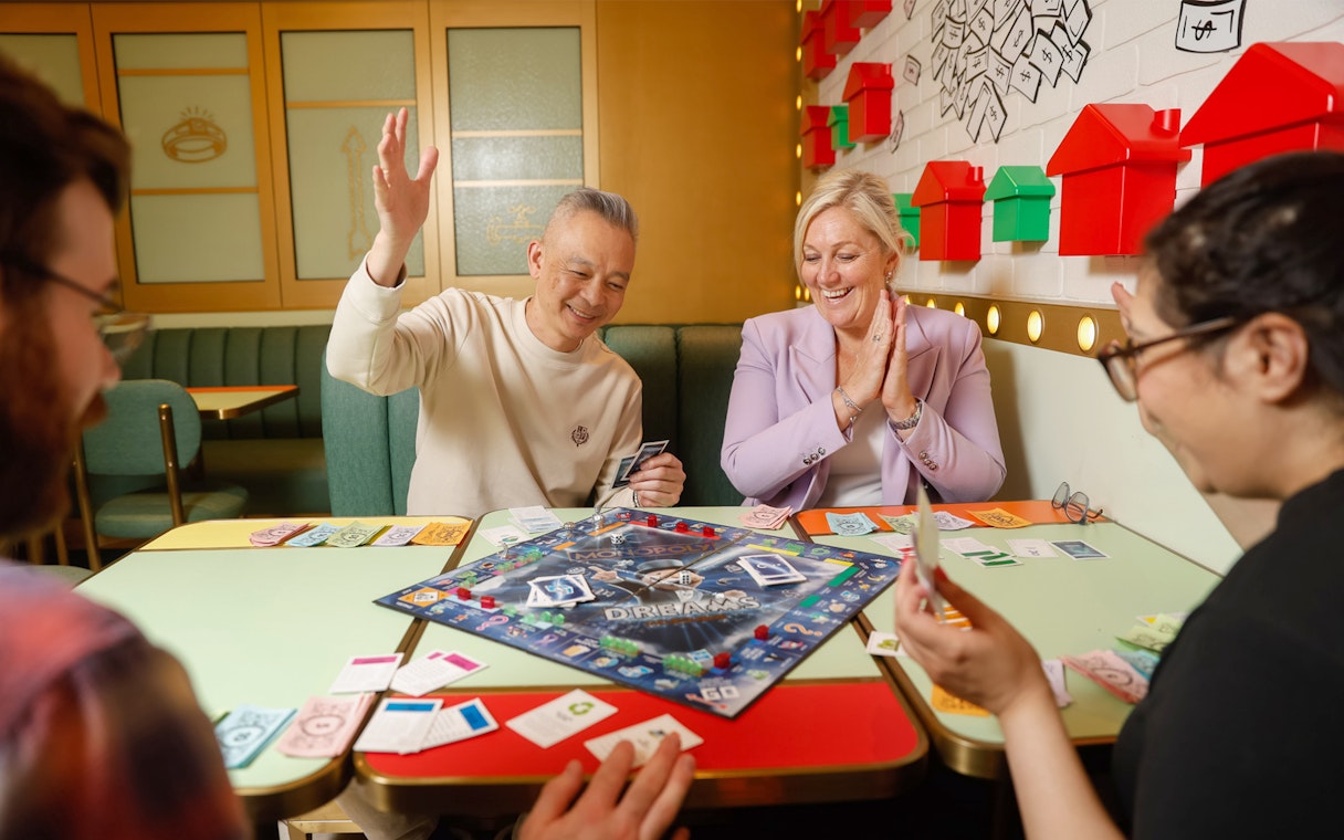 People playing Monopoly Dreams board game in Melbourne attraction.
