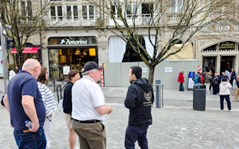 Group on a walking tour near Livraria Lello in Porto, Portugal.