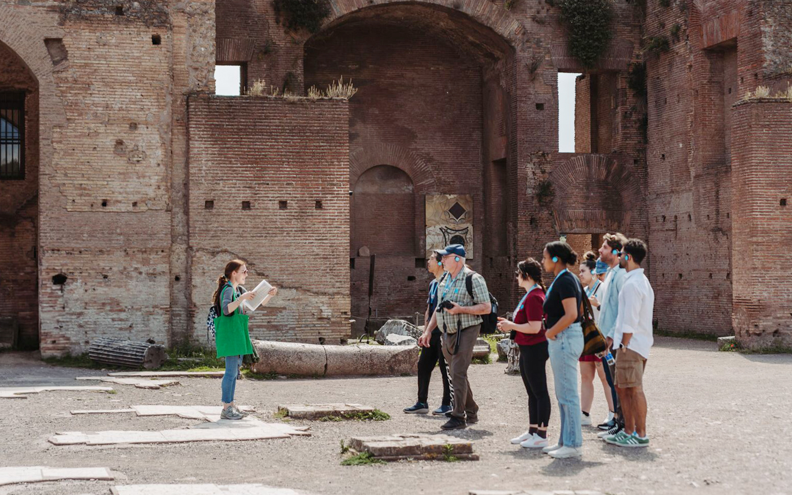 Tour guide leading a group at the Colosseum in Rome.
