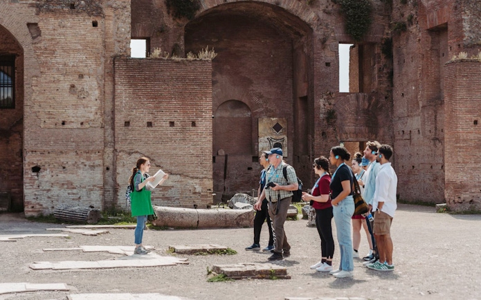 Tour guide leading a group at the Colosseum in Rome.