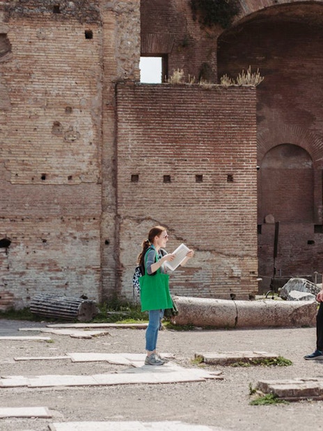 Tour guide leading a group at the Colosseum in Rome.