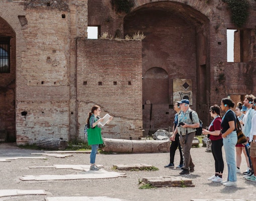 Tour guide leading a group at the Colosseum in Rome.