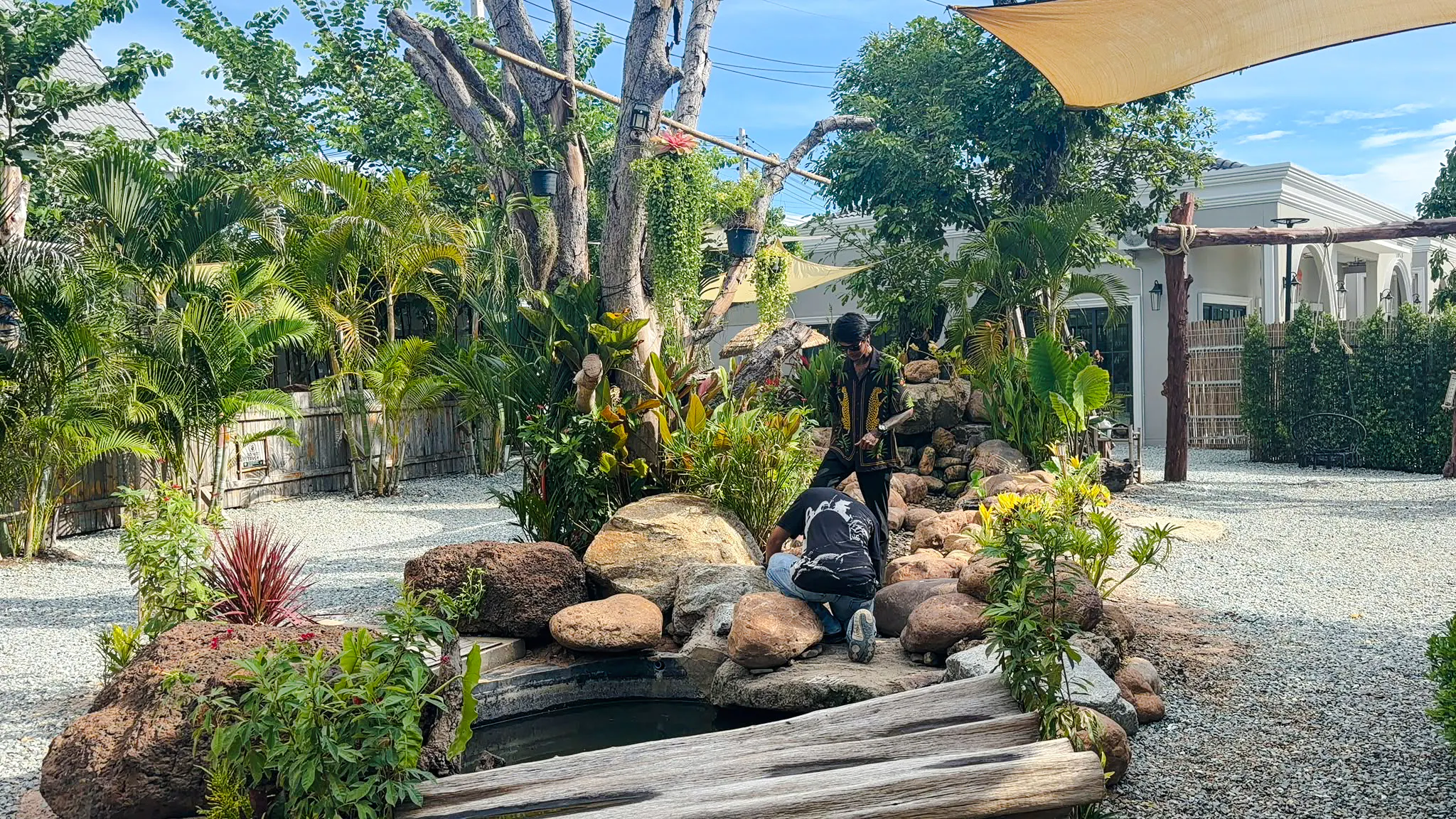 Visitors exploring garden area at Le Refuge Animal Sanctuary in Pattaya.