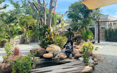 Visitors exploring garden area at Le Refuge Animal Sanctuary in Pattaya.