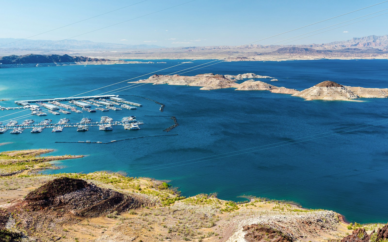 Aerial view of Lake Mead marina with boats, surrounded by desert landscape.
