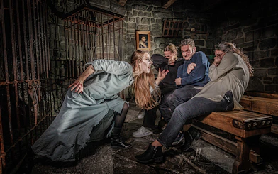 Witch scaring visitors at Berlin Dungeon attraction.