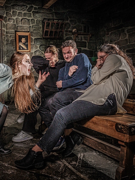 Witch scaring visitors at Berlin Dungeon attraction.