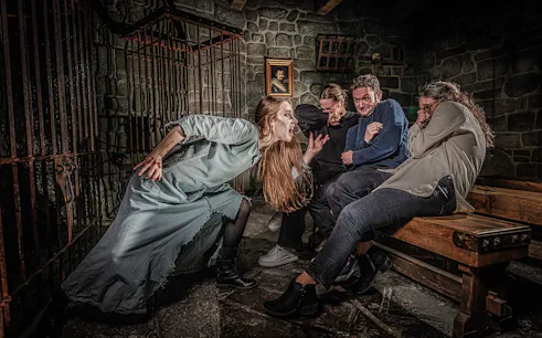 Witch scaring visitors at Berlin Dungeon attraction.