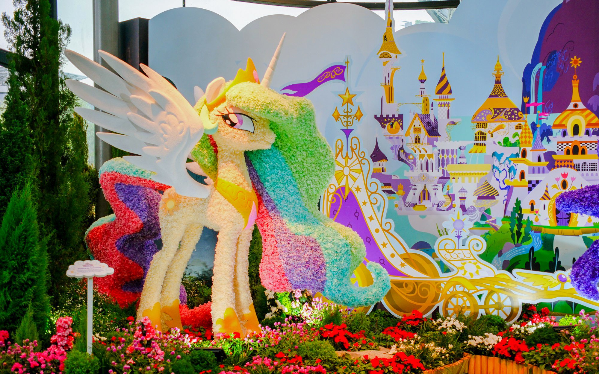 My Little Pony floral sculpture at Gardens by the Bay, Singapore, with fantasy castle backdrop.