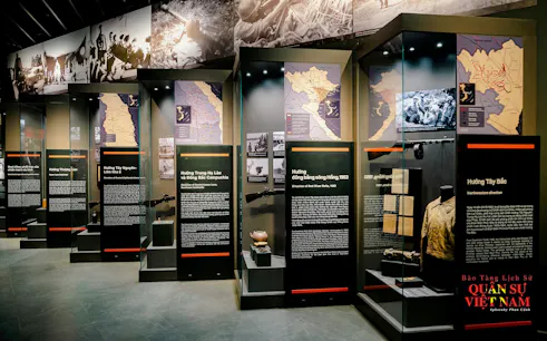 Hanoi Military History Museum exhibit with maps and historical artifacts.