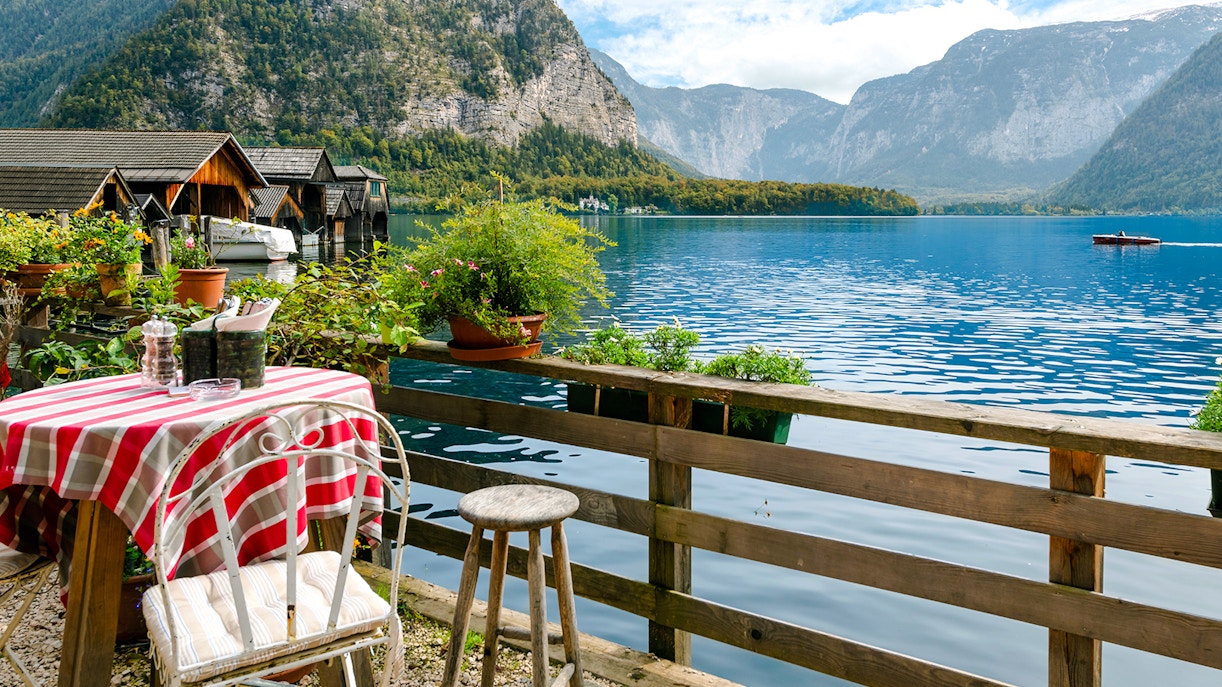 Outdoor cafe table overlooking lake and Alps in Hallstatt, Austria.