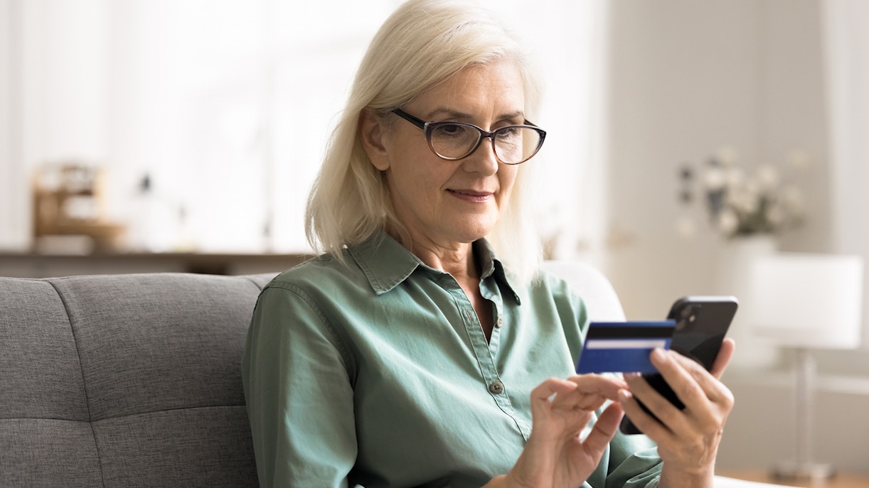 Woman purchasing tickets on smartphone