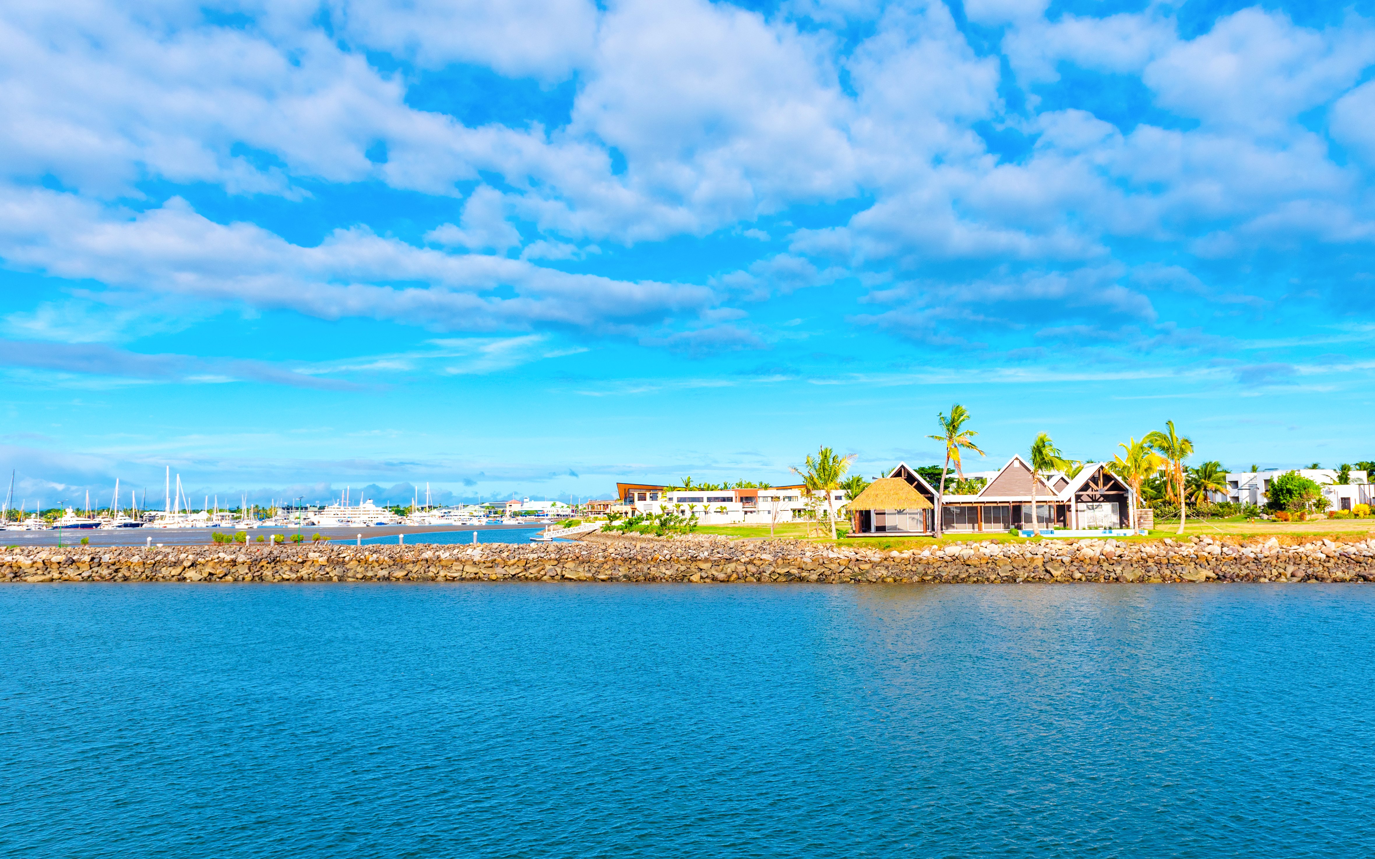 Landscape view of Denarau port with boats and waterfront buildings in Nadi, Fiji.