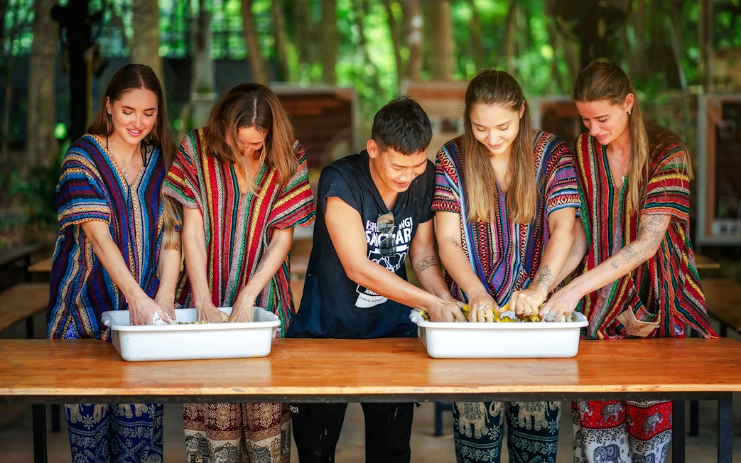 Visitors preparing food for elephants at Elephant Jungle Sanctuary, Phuket.
